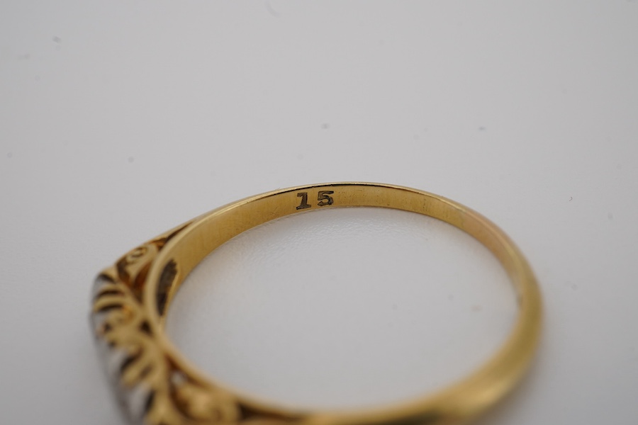 An early 20th century yellow metal and graduated five stone diamond set half hoop ring, size N, gross weight 2 grams. Condition - fair